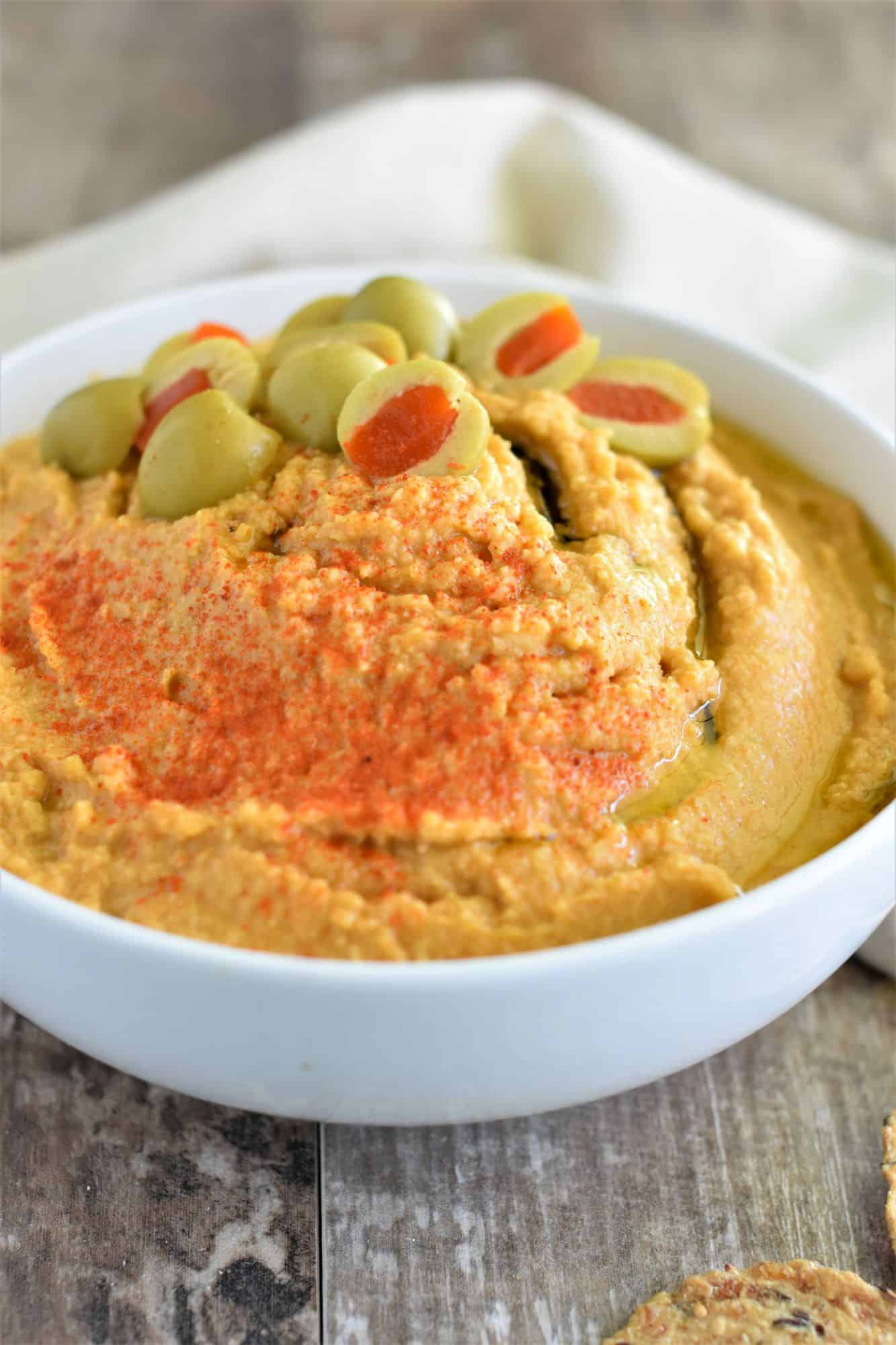 front view of hummus in white bowl