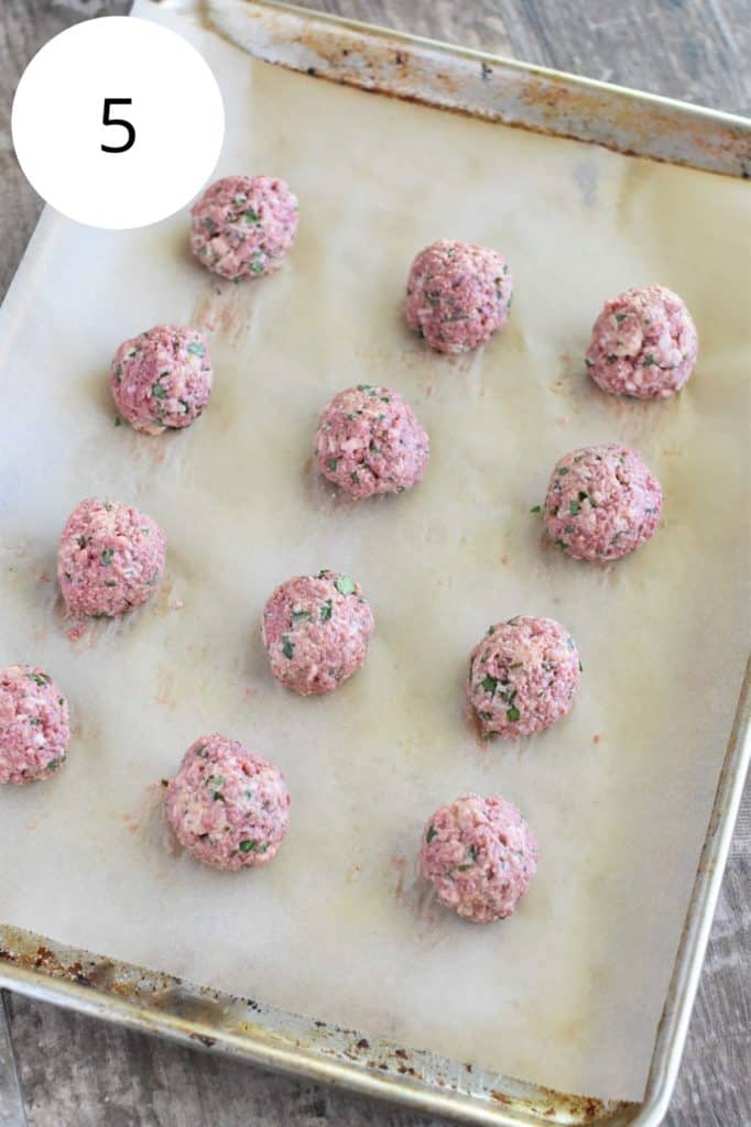 uncooked meatballs on parchment-lined baking sheet