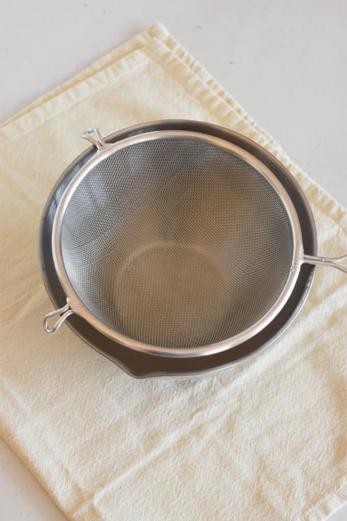 mesh strainer sitting over a mixing bowl