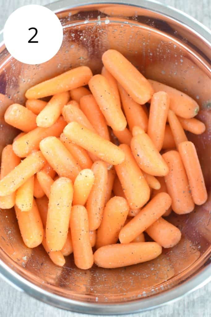 seasoned baby carrots in a mixing bowl