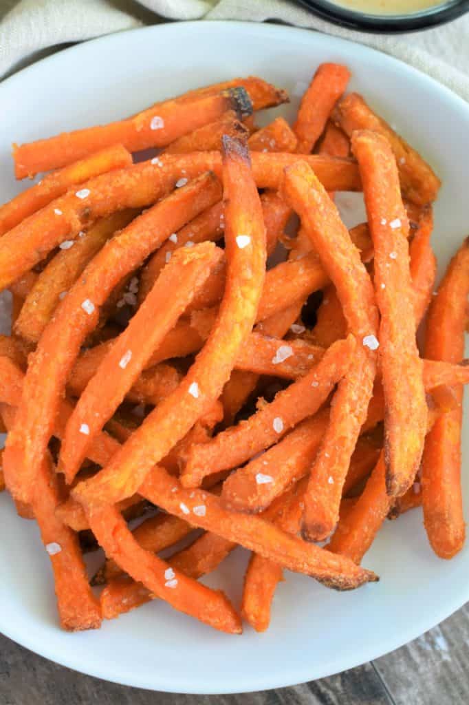 overhead of sweet potato fries on a white plate