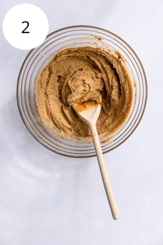 butter, peanut butter and sugar combined in mixing bowl with wooden spoon