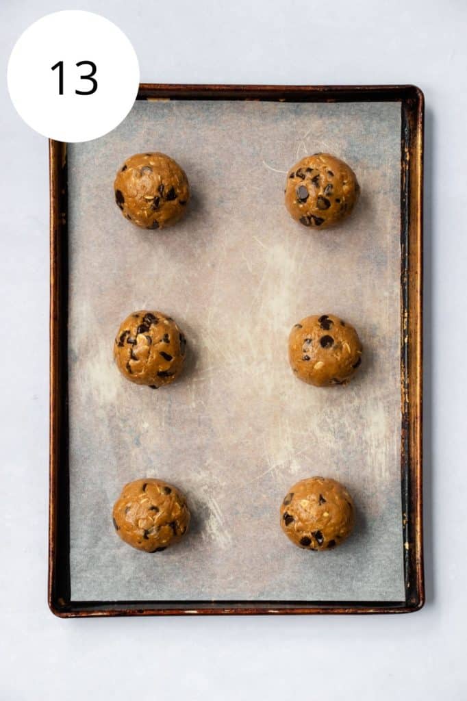 rolled cookie dough balls on parchment-lined baking sheet