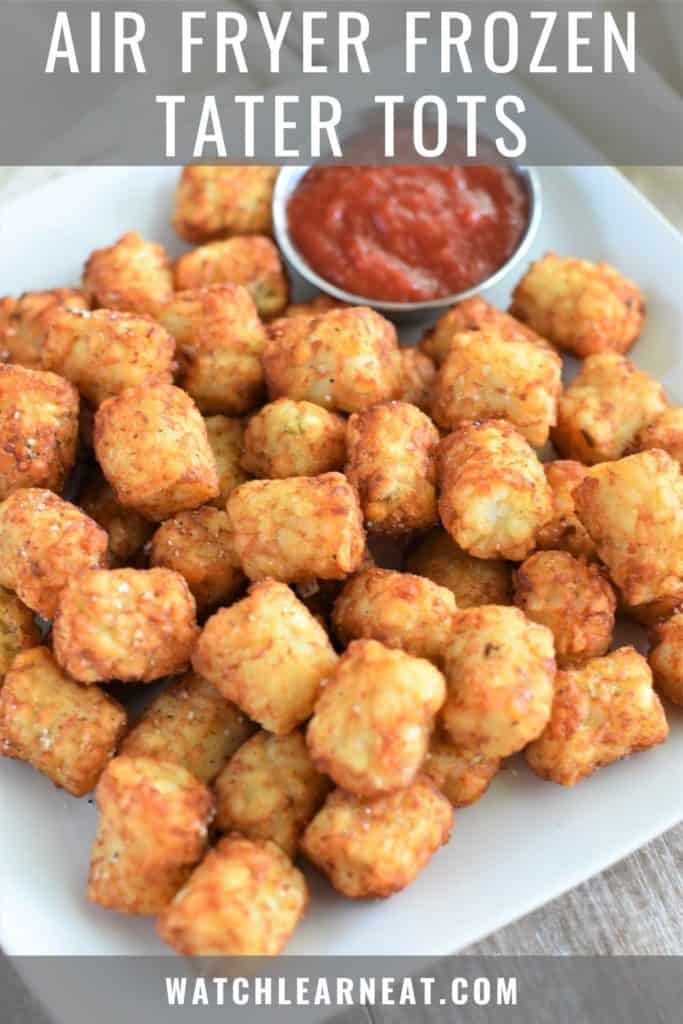 pin showing tater tots on white plate with cup of ketchup
