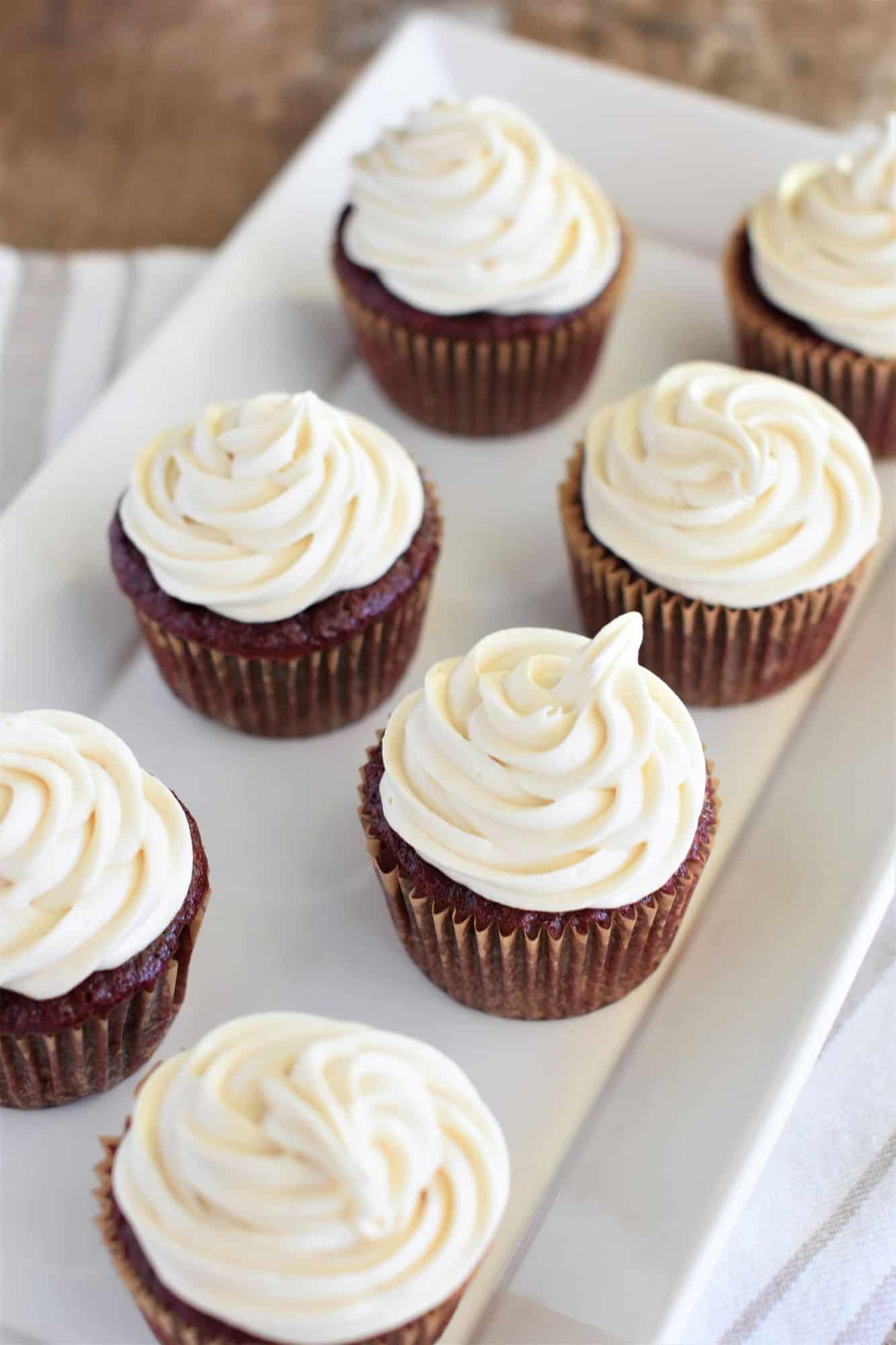 cupcakes with frosting on a white serving plate