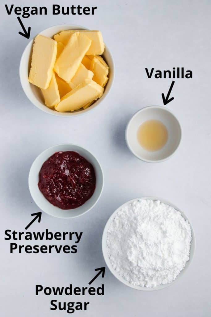 overhead of ingredients for frosting in white bowls with text labels