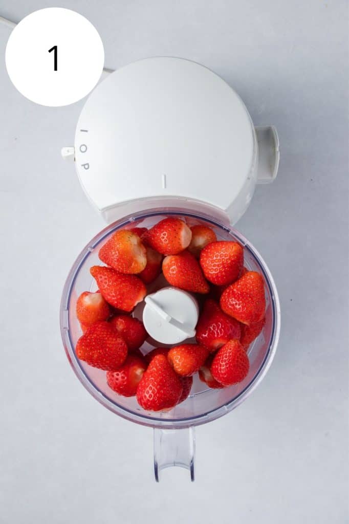 strawberries in food processor before being pureed