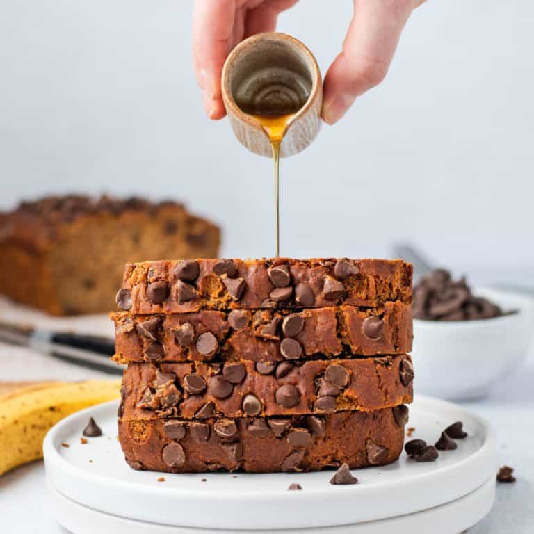 Pour maple syrup over stack of banana bread slices