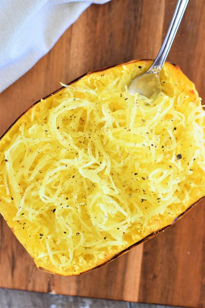 overhead of one of the cooked spaghetti squash halves with a fork in it