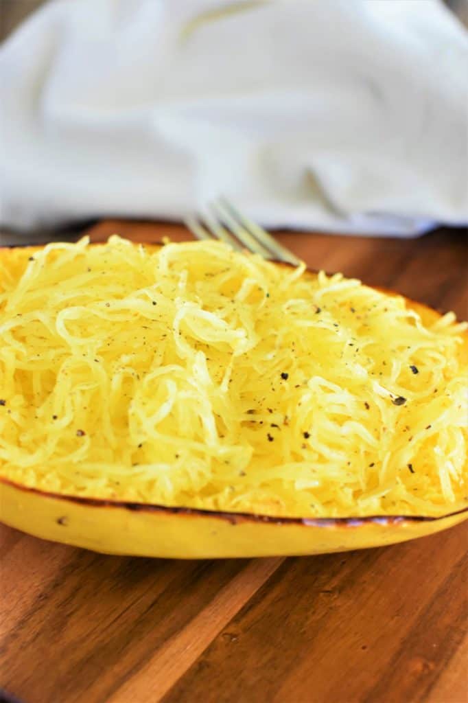 front view of spaghetti squash after being cooked on a wooden board
