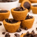 close-up of three cookie cups surrounded by chocolate chips