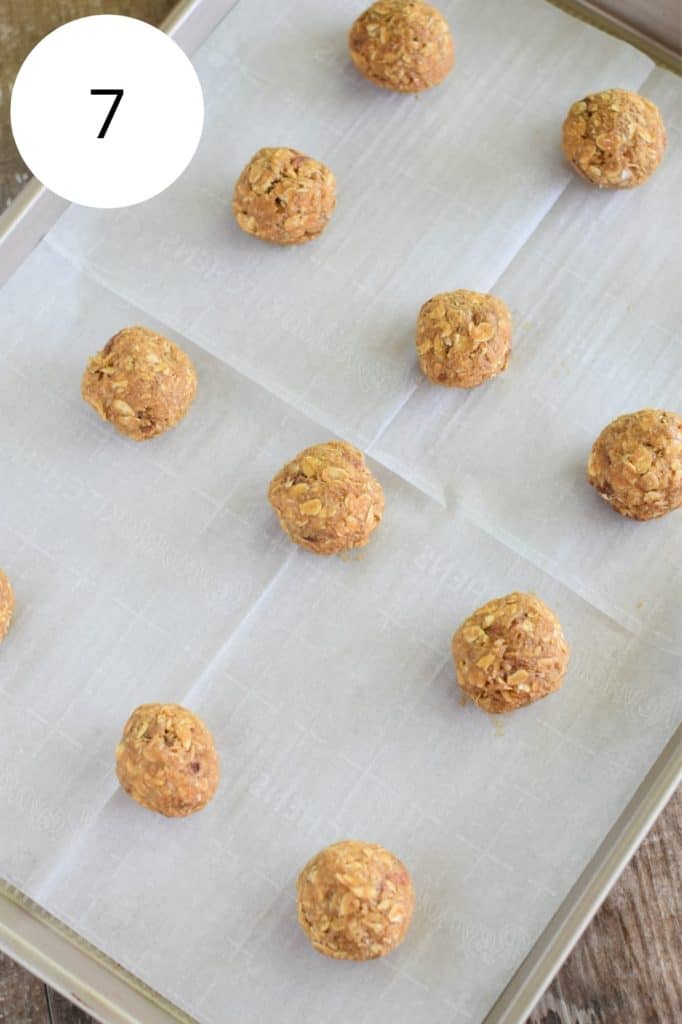 cookie dough balls on baking sheet with parchment paper