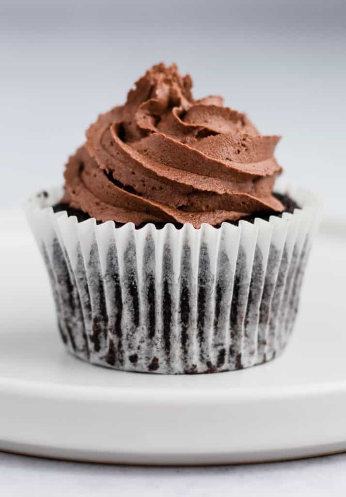 close-up of single chocolate cupcake on a white plate