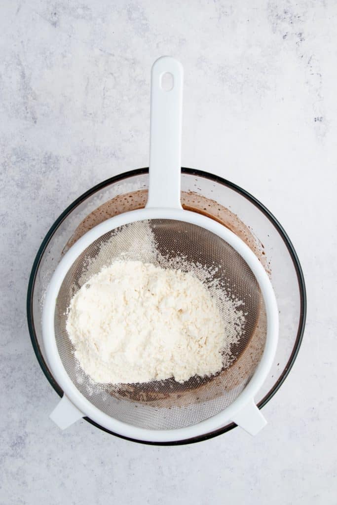 Sifting flour mixture into the chocolate mixture