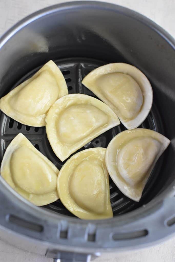 pierogies in air fryer after flipping and spraying with oil
