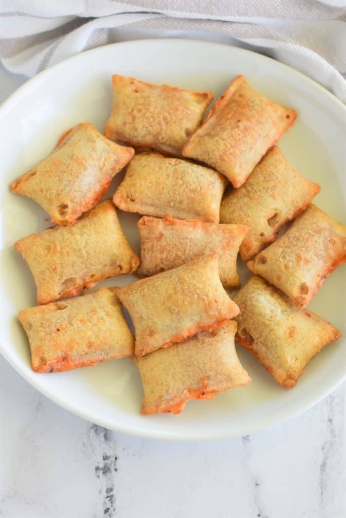 overhead view of pizza rolls on a white plate