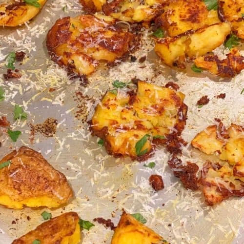smashed potatoes on a tray with toppings