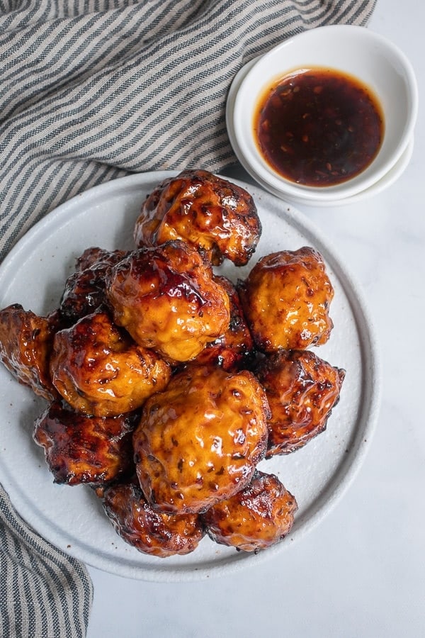 air fryer cauliflower wings in teriyaki sauce on a plate