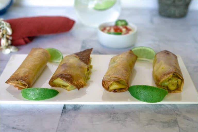 avocado spring rolls on a white serving tray