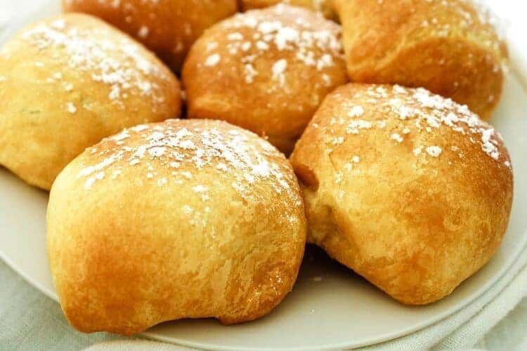 air fried oreos on a white plate topped with powdered sugar