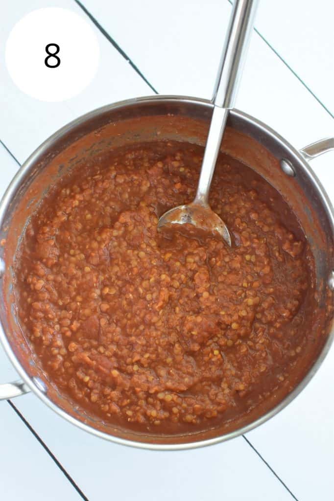 sauce in saucepan after cooking with serving spoon in it