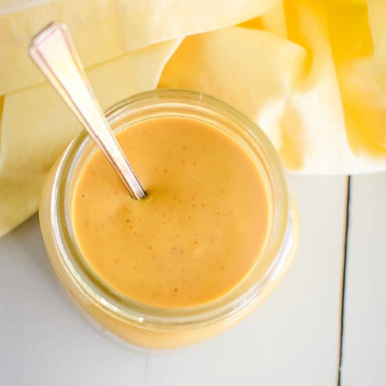 close-up of dipping sauce in mason jar with a spoon in it