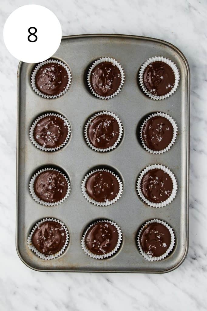 sea salt sprinkled on top of each of the peanut butter cups in the cupcake pan