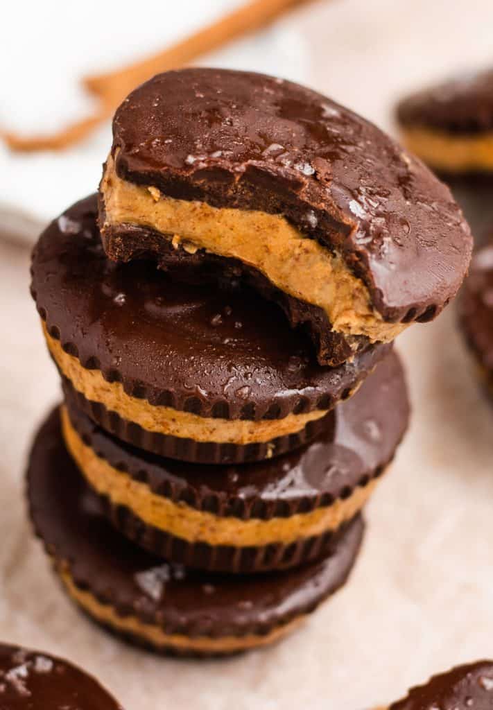 close-up stack of vegan peanut butter cups with bite taken out of the top one