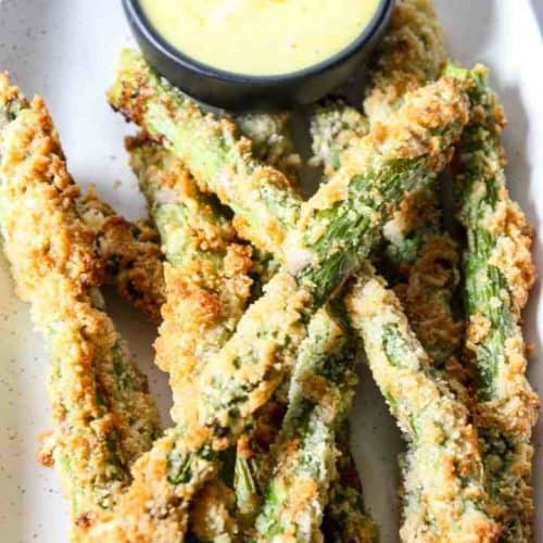 asparagus fries on serving dish with side of dipping sauce