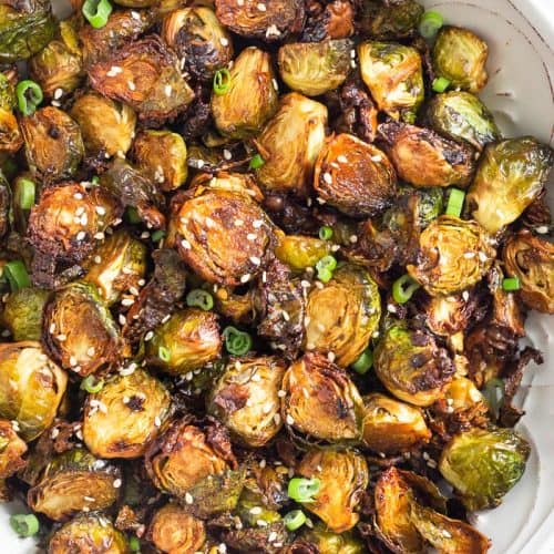 overhead of Brussels sprouts on white plate
