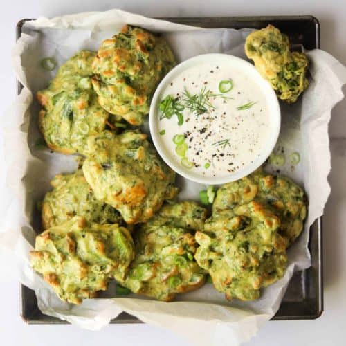 overhead of asparagus fritters with side of dipping sauce