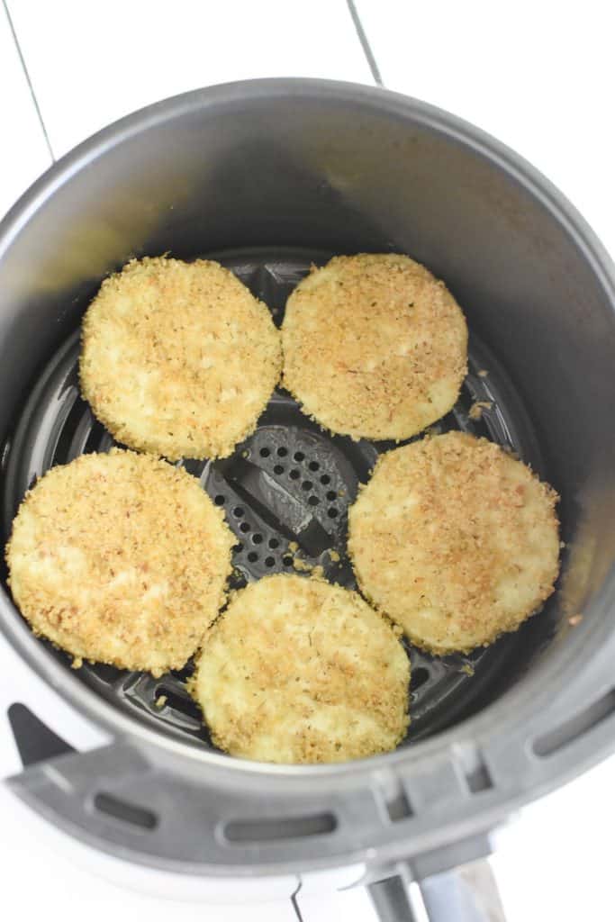 breaded eggplant slices in air fryer before cooking
