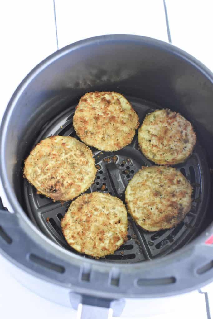breaded eggplant slices in air fryer after cooking