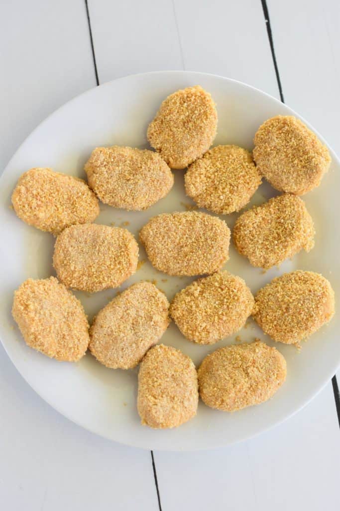 overhead of breaded nuggets on a white plate