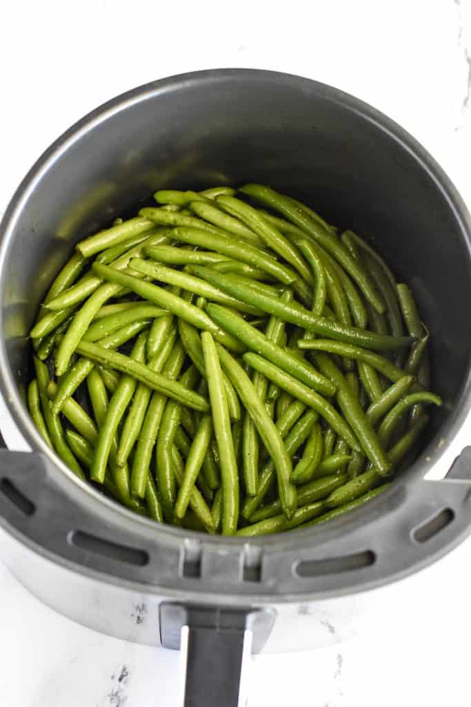green beans in air fryer before cooking.