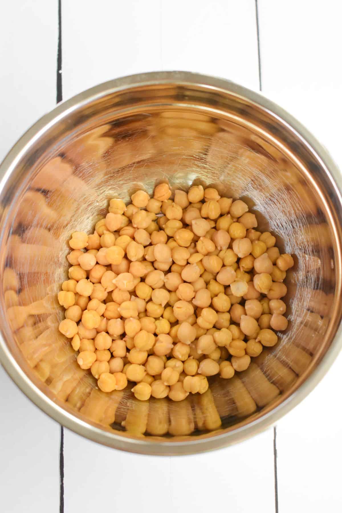 Overhead view of chickpeas in a mixing bowl.