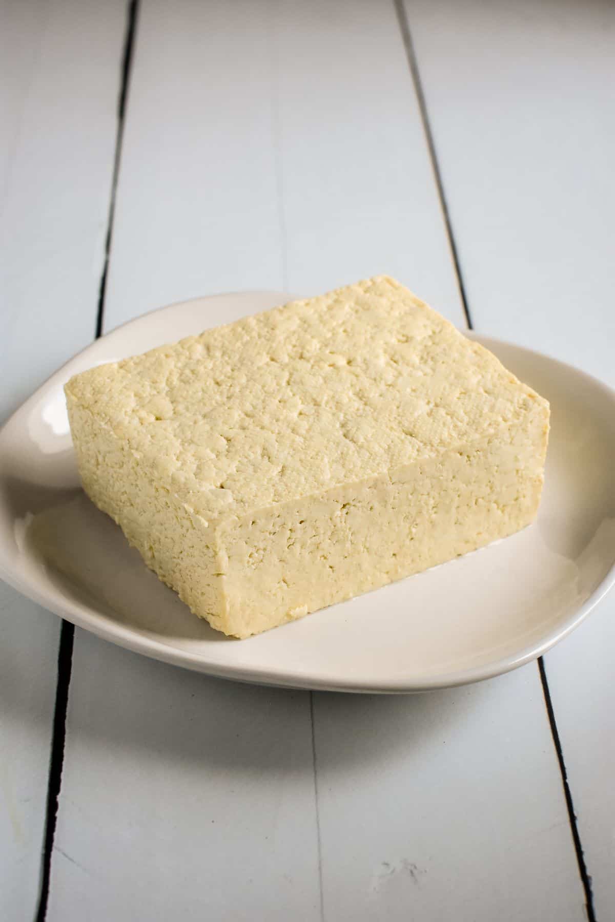Front view of tofu on a white plate.