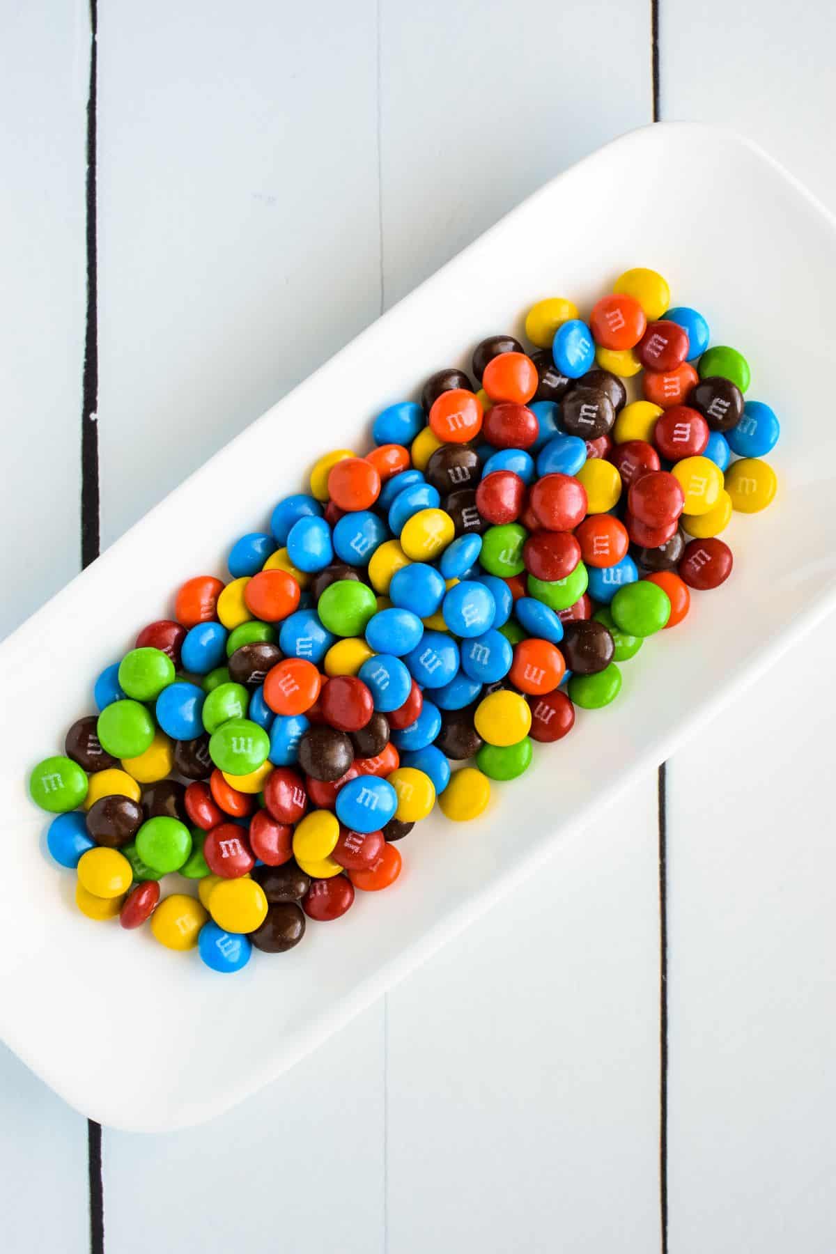 White dish of M&M's overhead view.