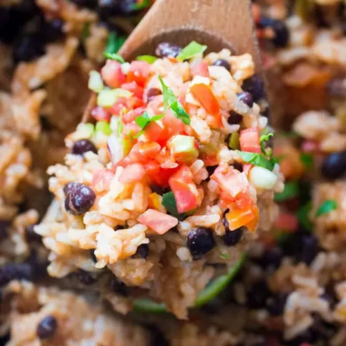 Slow Cooker Rice and Beans on a wooden spoon.