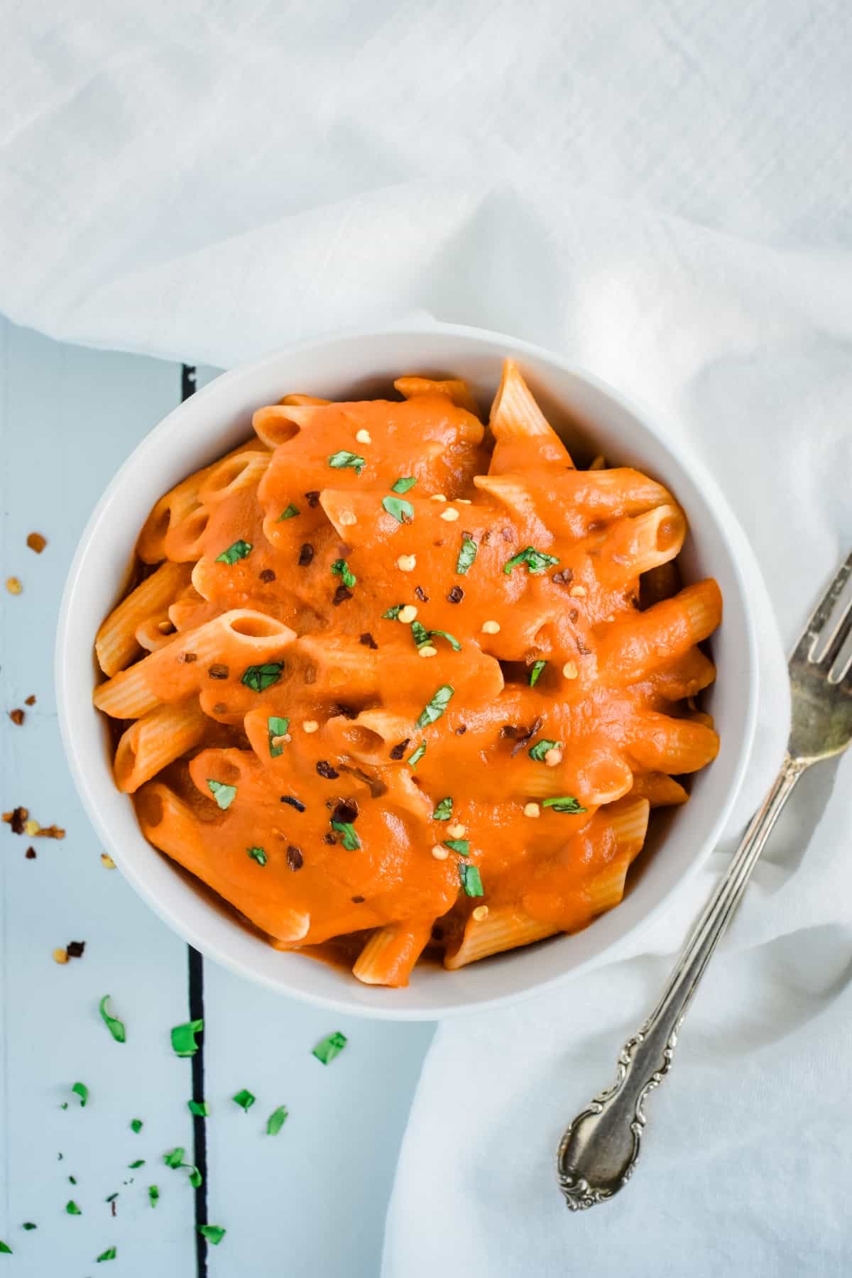 Vodka sauce on pasta in a bowl.