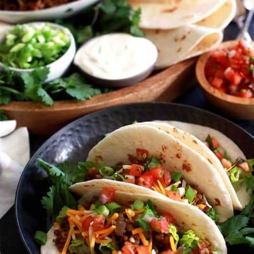 Slow cooker brown rice and lentil tacos on a plate.