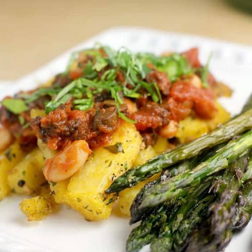Quick Bolognese over Polenta Fries on a plate.