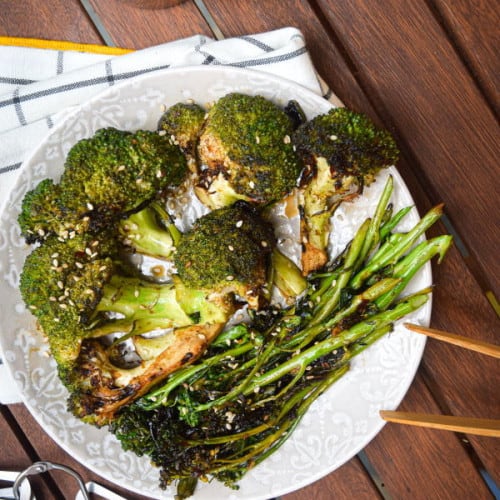 Grilled Broccoli on a plate with a measuring spoon.