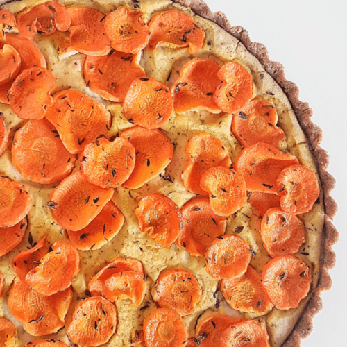 Cannellini Bean and Carrot Tart on a white surface.
