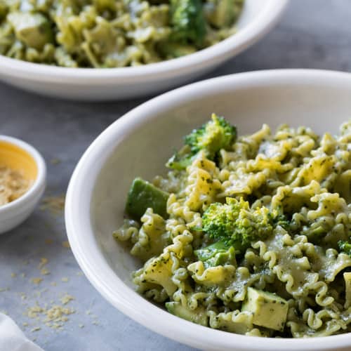 Vegan Pesto Pasta with Broccoli and Avocado in a bowl.