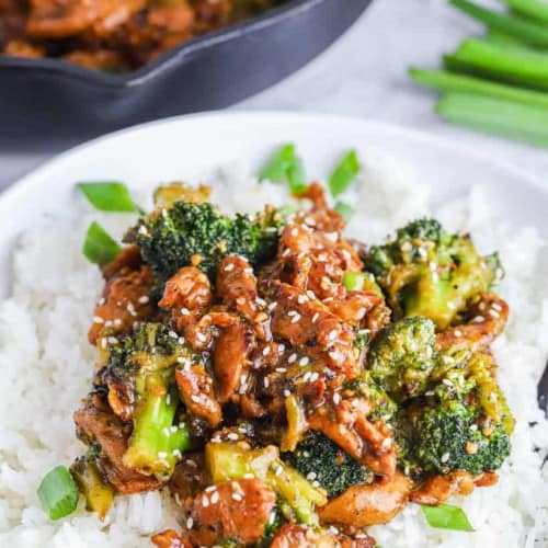 vegan beef and broccoli served over rice on a plate.