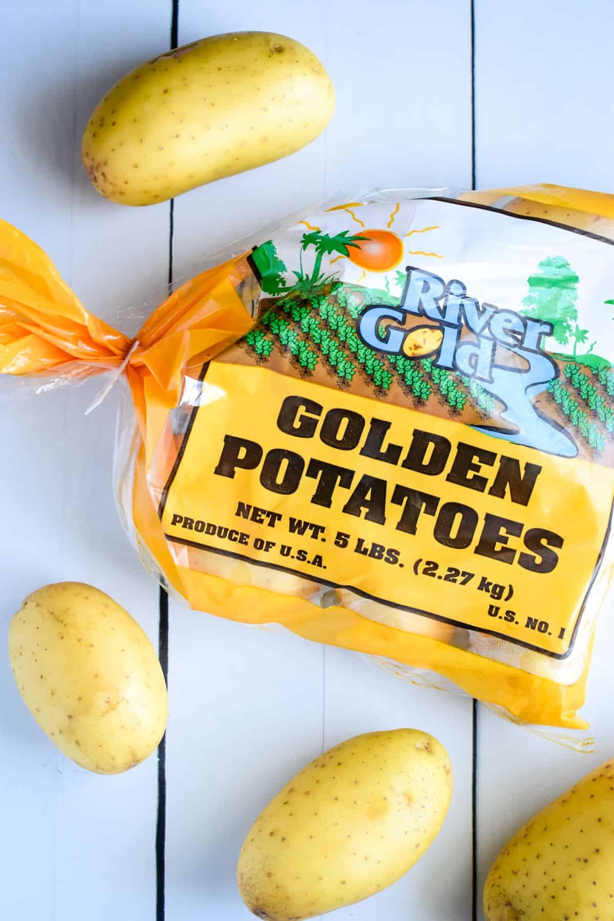 Bag of golden potatoes on table.
