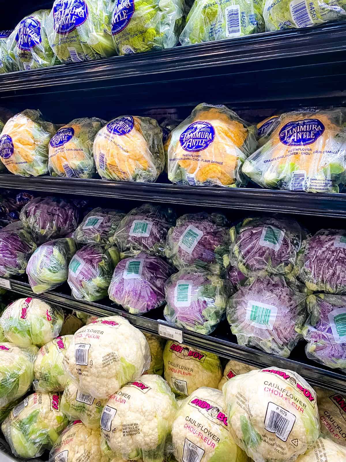 Cauliflower in packages on shelves.
