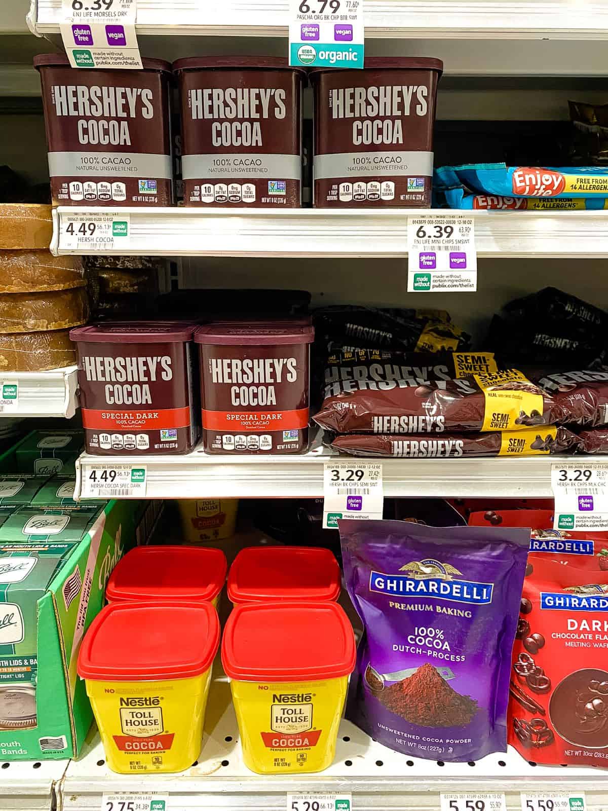 Different brands of Cocoa Powder on supermarket shelves.