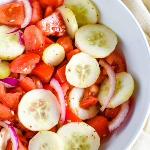 Cucumber Tomato Salad in a white bowl.